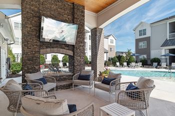A patio with a fireplace and chairs is shown.